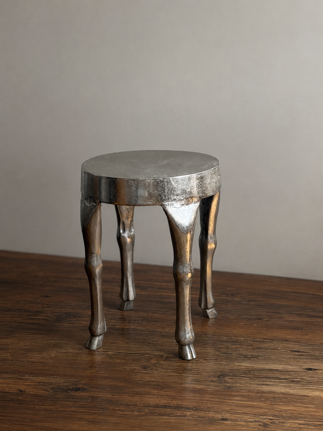 CAST ALUMINUM STOOL WITH HOOF-FOOTED LEGS